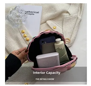 Internal view of shell cross-body bag showing space for phone and makeup