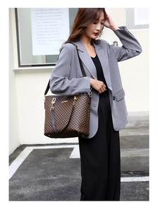 Classic patterned tote bag detail showing large capacity design and leather shoulder strap