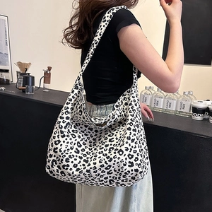 Fashionable leopard print canvas tote bag for women shown in a cafe setting