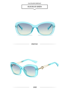 Detail of blue-green cat-eye sunglasses with golden geometric hollowed-out metal temples