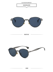 Détail de lunettes de soleil rondes en métal gris fusil avec verres foncés