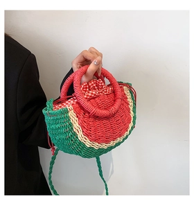 Detail of creative watermelon straw bag with red ring handle and checkered drawstring liner