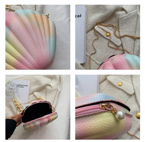 Detail view of rainbow shell bag with pebble texture, gold chain and pearl zipper