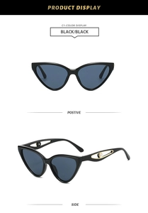 Détail de lunettes œil de chat noires avec branche dorée ajourée et perle blanche élégante