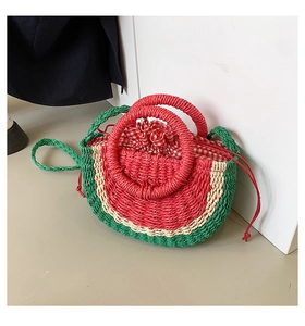Detail of watermelon-shaped straw handbag with tricolor weaving and drawstring liner