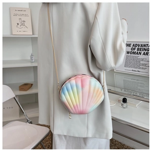 Close-up of rainbow shell bag with lychee texture, gold chain and pearl zipper detail