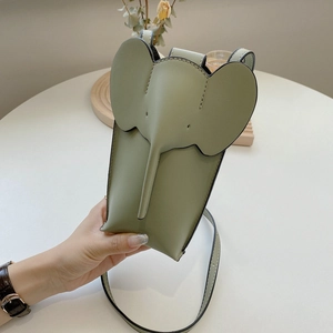 Detail of sage green elephant shaped phone bag in matte PU leather with crossbody strap