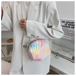 Detail of shell-shaped crossbody bag with iridescent gradient colors and a pearl zipper pull