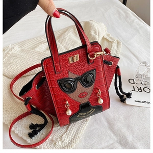 Detail of red crocodile texture handbag with fashion illustration and pearl earring accents