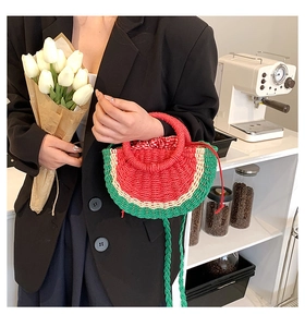 Detail of watermelon straw bag with red gingham lining and green woven shoulder strap