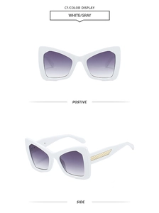Detail of white butterfly frame sunglasses featuring golden mesh texture on the temples