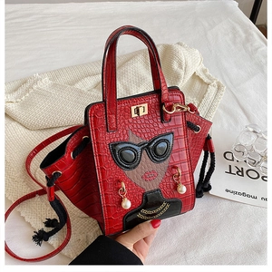 Detail of red crocodile texture bag featuring a stylish portrait with 3D pearl accessories