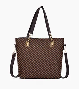 Front view of geometric pattern tote bag with black handles and golden hardware details