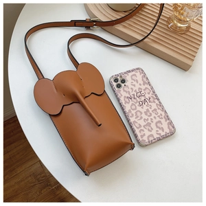 Brown elephant leather phone crossbody bag with adjustable strap on white desk