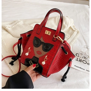 Detail of red crocodile pattern handbag featuring a stylish woman with sunglasses and pearls