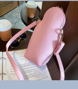 Close-up of pink PU leather texture and gold zipper detail on the matryoshka bag