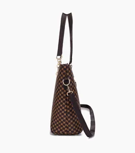 Side view of dark brown tote bag with vintage geometric pattern and golden D-ring