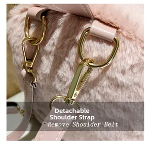 Detail of pink faux fur backpack showing the detachable golden metal clip and leather strap