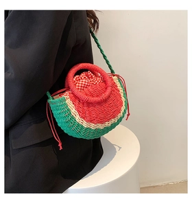 Macro detail of watermelon straw bag showing red checked lining and drawstring closure