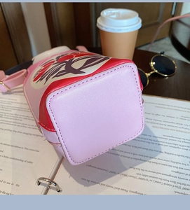 Close-up of square base and fine stitching on a pink nesting doll PU leather bucket bag
