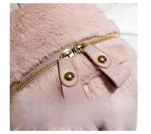 Close-up of durable metal double zippers on pink plush bunny backpack with faux fur