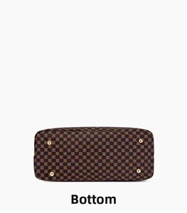 Detail of vintage patterned handbag bottom with four protective gold metal feet studs