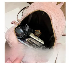 Internal storage view of the pink faux fur backpack showing phone and umbrella capacity