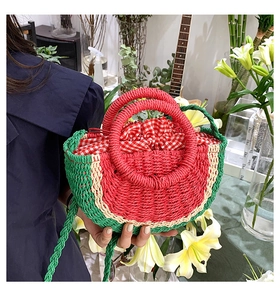 Detail of handmade watermelon straw bag with red gingham drawstring lining