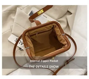 Detail view of the retro shell bag showing a functional internal zipper pocket and lining