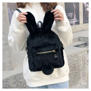 Close-up of black plush bunny backpack with long ears and fluffy pom-pom tail detail