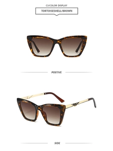 Detail of tortoiseshell cat-eye sunglasses with gold metal carved hinges and brown lenses