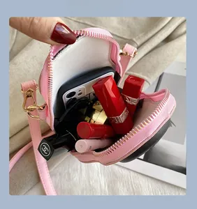 Pink heart-shaped PU crossbody bag interior showing phone and lipstick storage