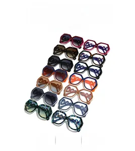 Flat lay of colorful polygon oversized sunglasses with unique hollow chain temple design