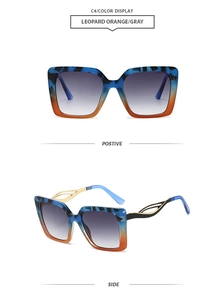 Detail of square oversized sunglasses with blue leopard and orange gradient frame