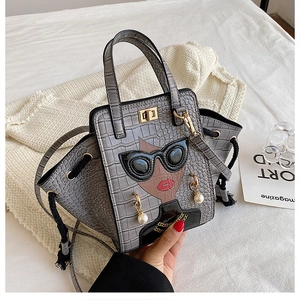 Macro view of grey crocodile pattern bag with creative lady portrait and 3D sunglasses