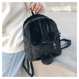 Close-up of black fuzzy faux fur rabbit backpack with plush ears and gold zipper detail