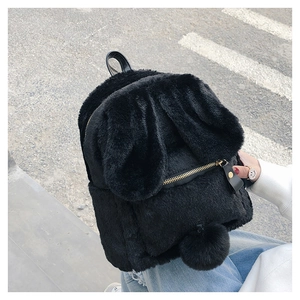Detail of cute black faux fur rabbit backpack with long ears and gold zipper hardware