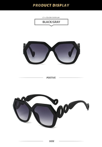 Detail of oversized polygon sunglasses with unique chain-link hollow temple design