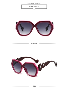 Detail of pink and purple hexagonal sunglasses featuring hollow ring temples and gradient lenses