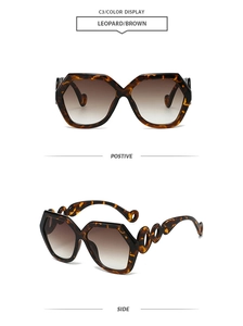 Detail of leopard print polygon sunglasses with brown gradient lenses and chain cut-out temples