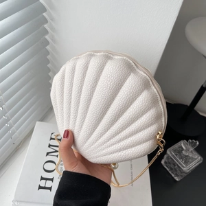 White shell-shaped leather crossbody bag with gold chain strap and pearl pendant