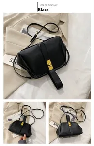 Detail view of black lychee grain leather handbag with gold clasp and studs