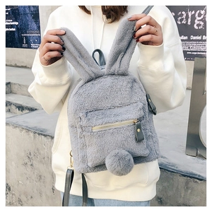 Close-up of plush rabbit backpack featuring long ears and golden zipper detail