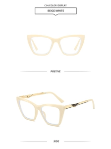 Detail view of beige cat-eye sunglasses with golden metal temples and geometric textures