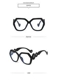 Detail view of black geometric oversized sunglasses with hollow chain design temples