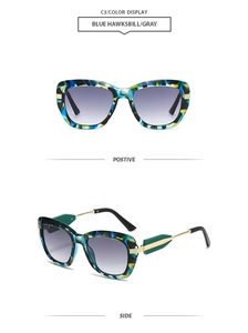 Detail view of blue hawksbill frame sunglasses with gradient gray lenses and metal hinge