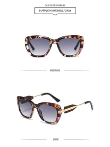 Detail view of purple tortoiseshell polygon sunglasses with gold metal temples and gray lens