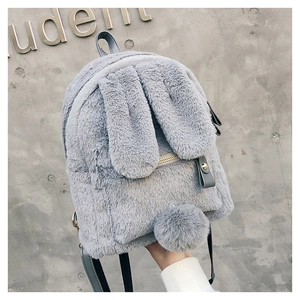 Detailed view of plush bunny ears and soft faux fur texture on gray backpack