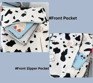 Detail view of the front pockets and zipper compartments on cow print canvas backpack