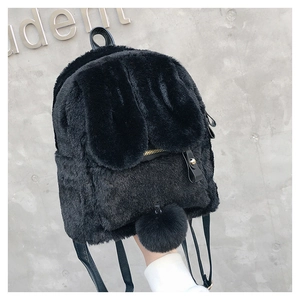Detail of cute black faux fur rabbit ear backpack featuring golden zipper and plush pompom